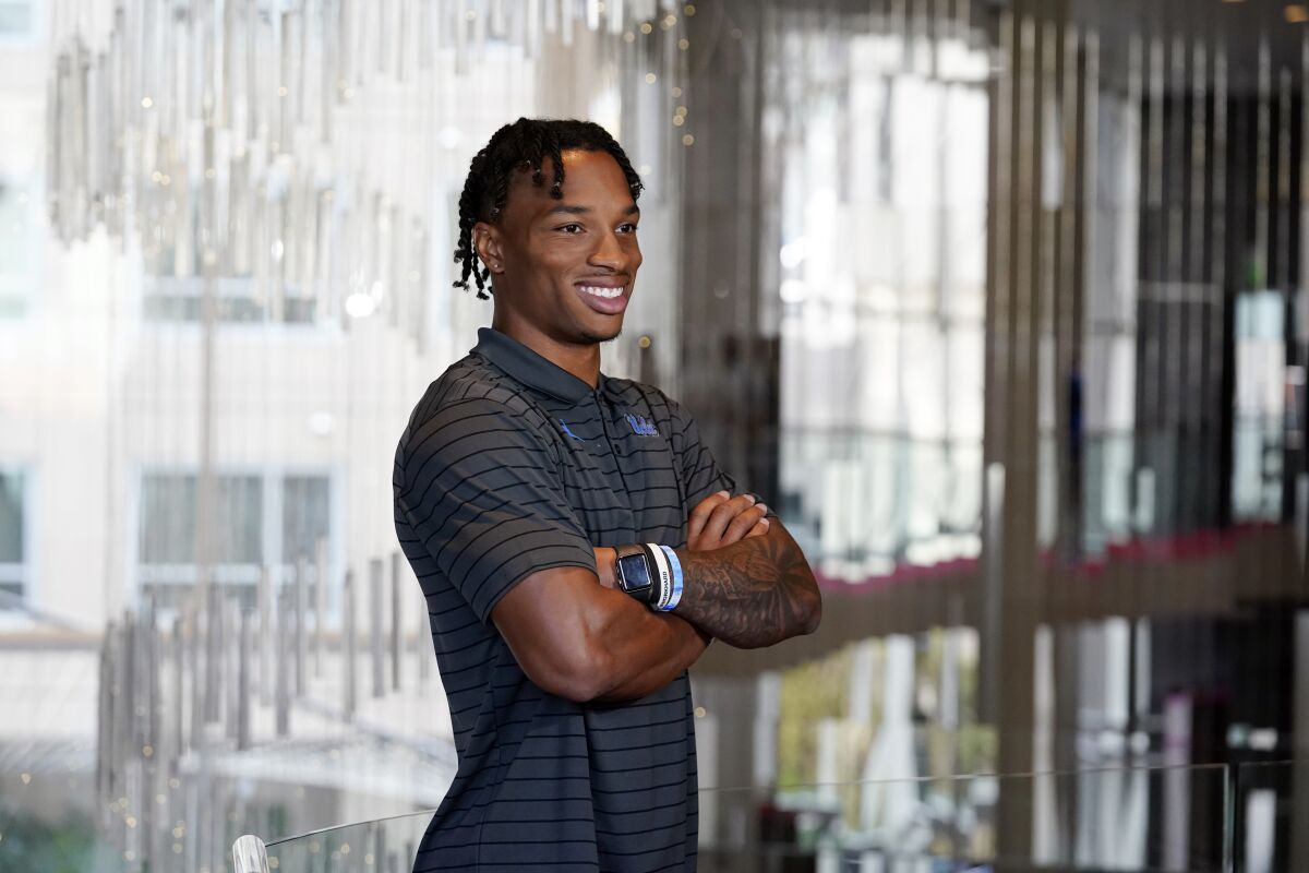 UCLA quarterback Dorian-Thompson Robinson poses for photos during the Pac-12 Conference NCAA college football Media Day