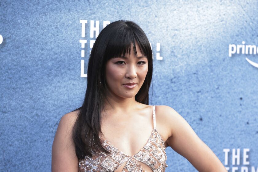 Constance Wu in a thin-strapped dress at a red carpet event