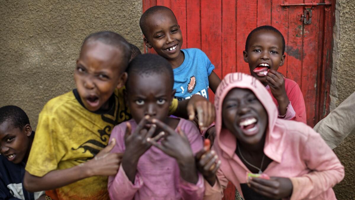 The children of genocide survivors and perpetrators share laughs in the reconciliation village of Mbyo, near Nyamata, Rwanda, April 4, 2019. It’s been 25 years since the mass genocide in Rwanda.
