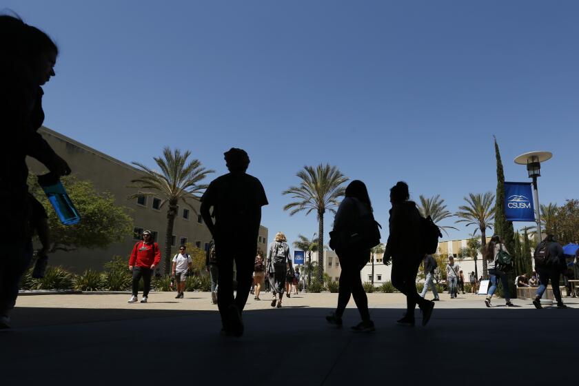 Students walk outside of Markstein Hall at Cal State San Marcos on April 10, 2019. Graduation rates are low for students trying to complete college in four years. (Photo by K.C. Alfred/San Diego Union-Tribune)