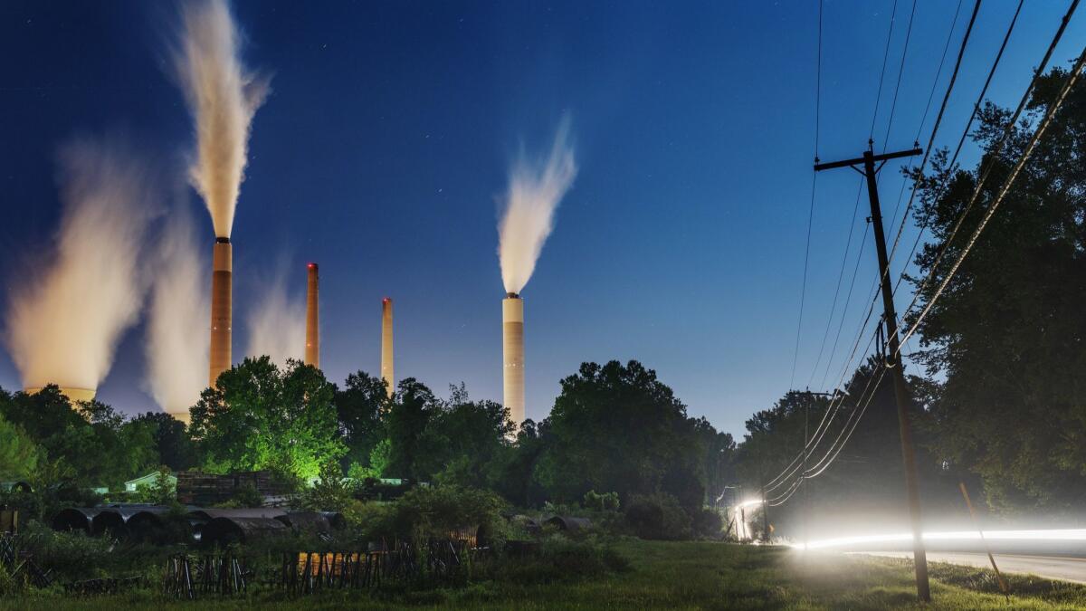 The John E. Amos Power Plant is seen from a field outside of Winfield, W.Va. Built in the 1970s, the coal-fired facility is the largest in the American Electric Power company's portfolio.