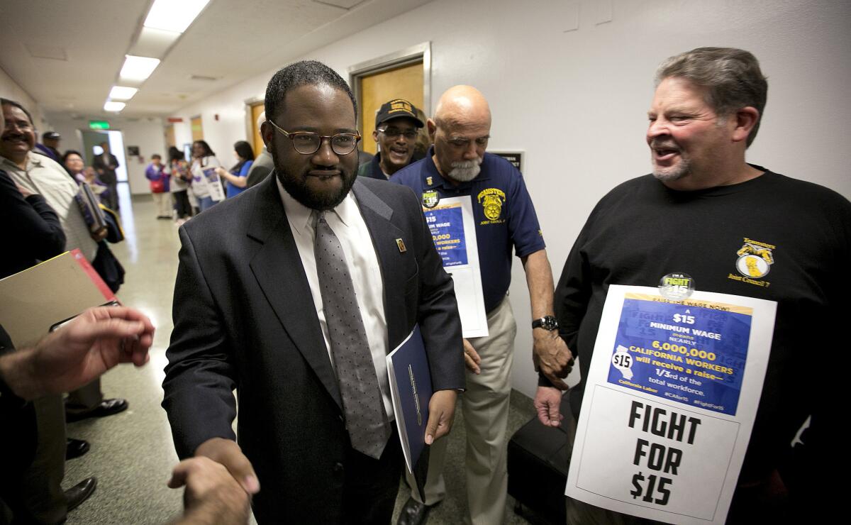 Assemblyman Sebastian Ridley-Thomas is greeted by supporters of a measure to raise the state's minimum wage.