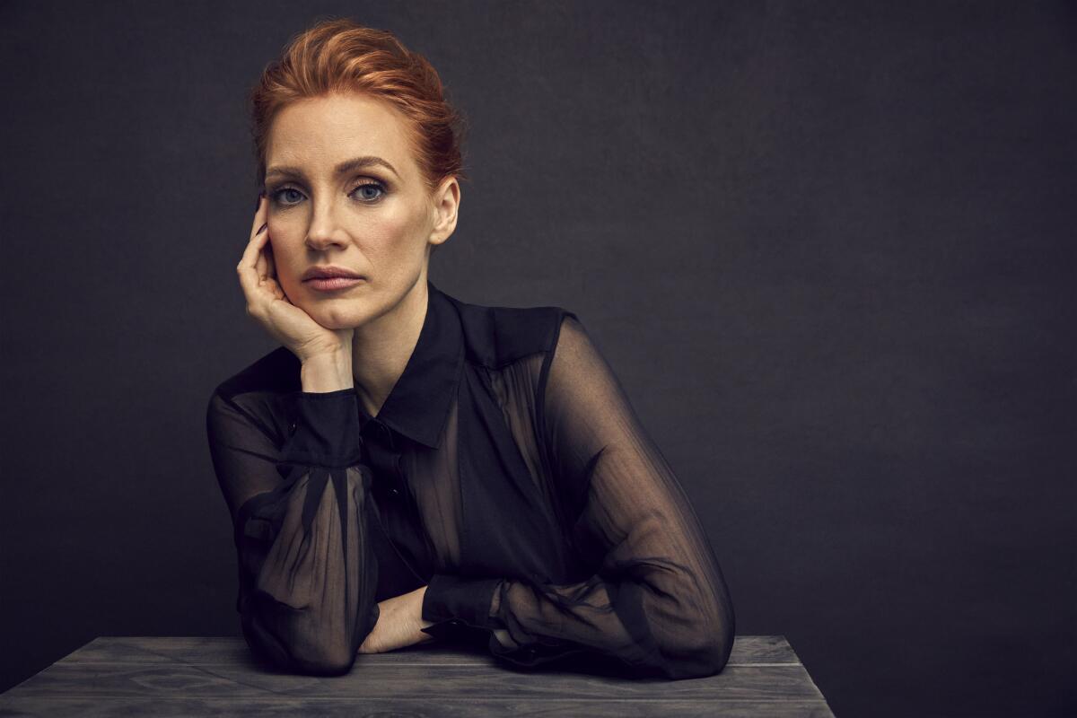Jessica Chastain rests her chin in her hand for a portrait.