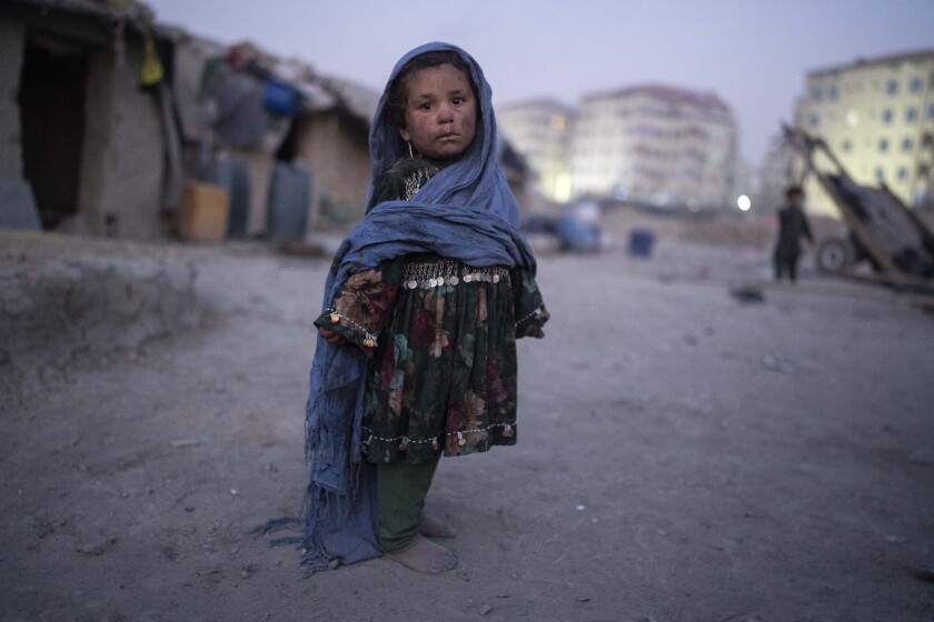 A child stands outside her home in a neighbourhood where many internally displaced people have been living for years, in Kabul, Afghanistan, Tuesday, Dec. 7, 2021. (AP Photo/Petros Giannakouris)