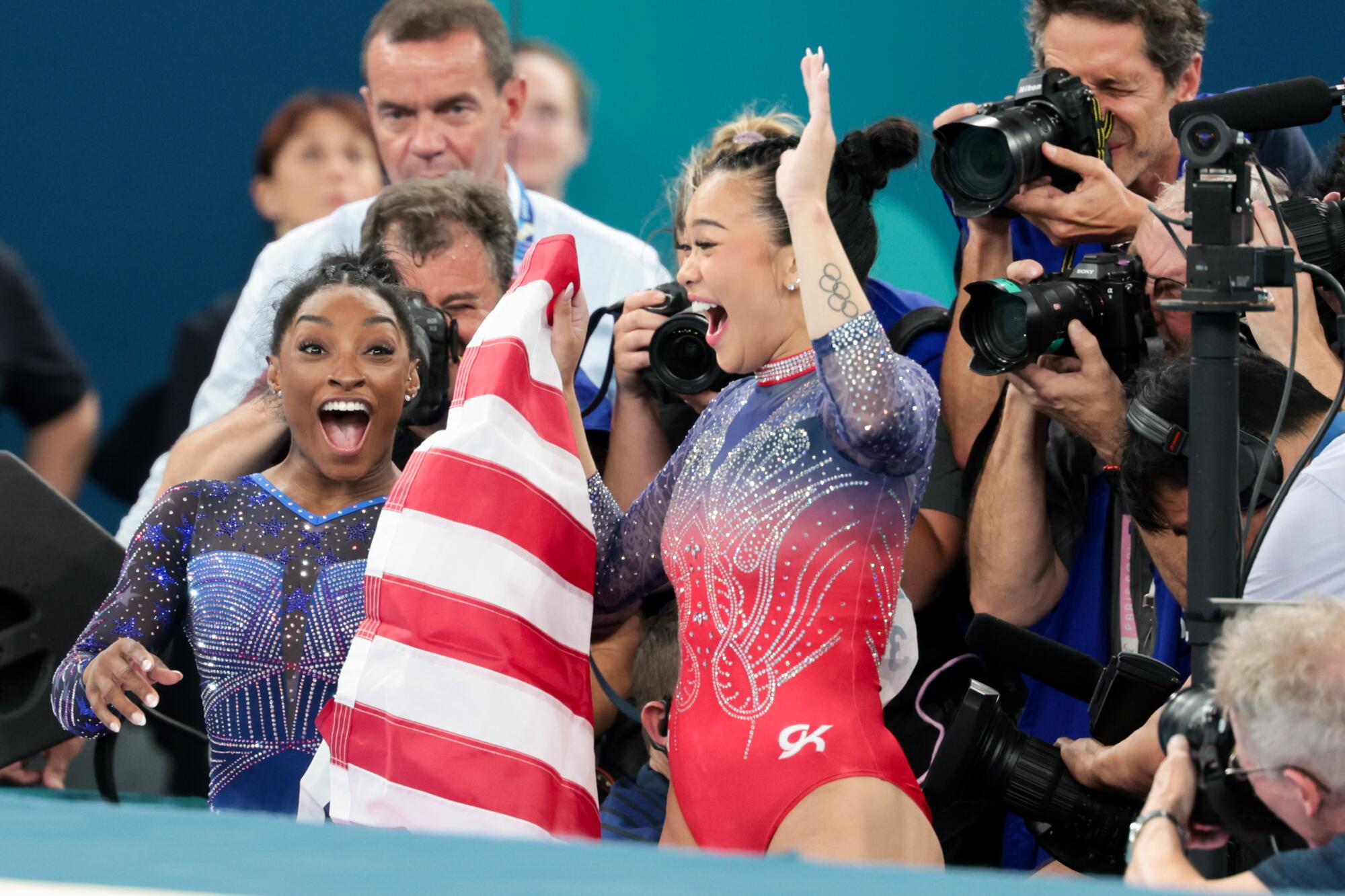 Simone Biles, left, celebrating with Suni Lee