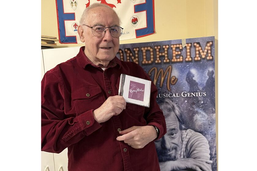 Author and journalist Paul Salsini holds a copy of Stephen Sondheim's first original cast recording of “Phinney's Rainbow” in Milwaukee on Dec. 1, 2022. The CD, which was lost, is a recording of the legendary composer's first student-led musical while he attended Williams College in 1948. (S. Barbara Goertz via AP)