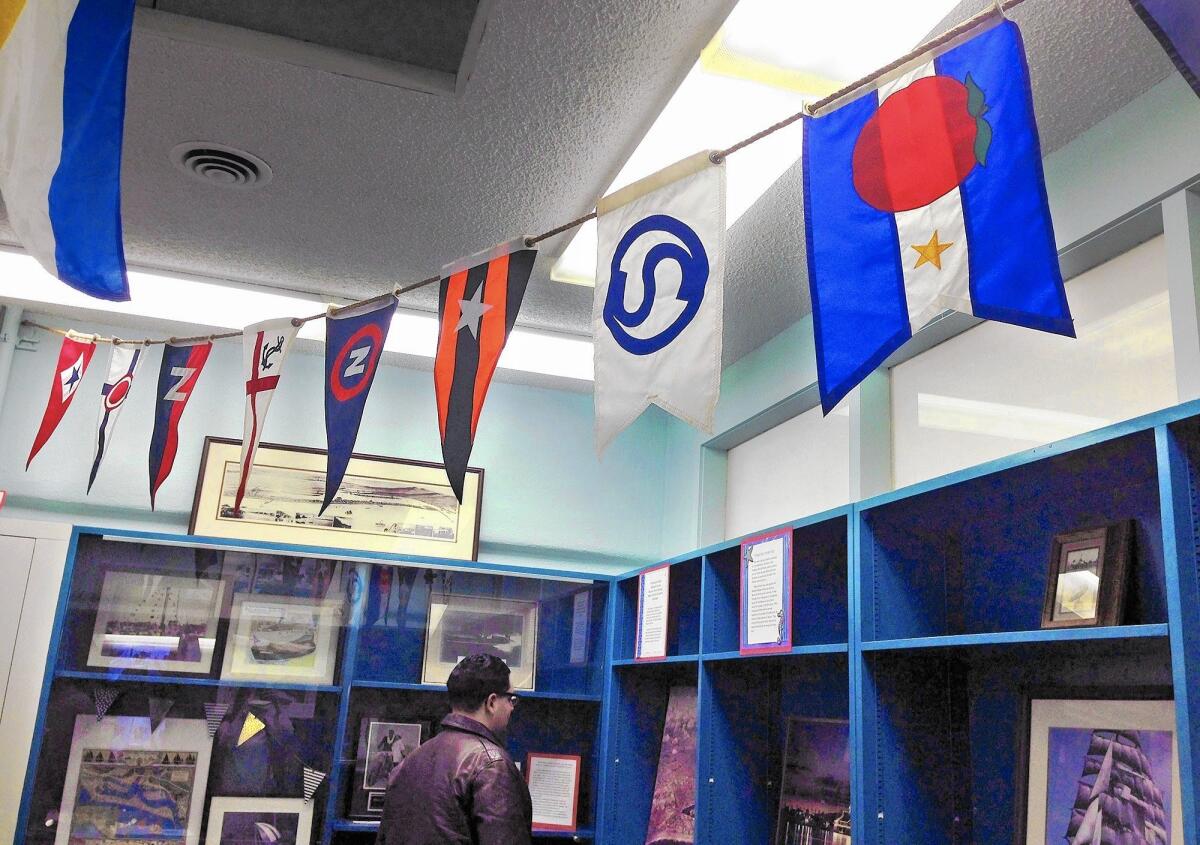 Burgees from each yacht club in Newport Beach are strung across the ceiling at the Newport Beach Historical Society's new location in the Balboa Branch Library.