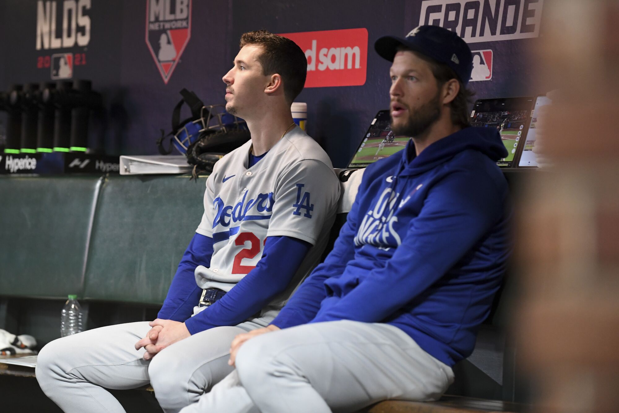 Los Angeles Dodgers starting pitcher Walker Buehler, left, sits with Clayton Kershaw in the dugout