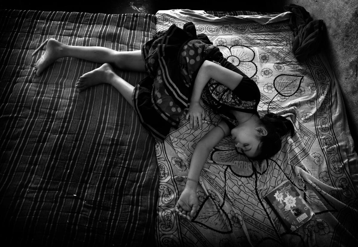 Sabhyata, 12, sleeps after reading a book.