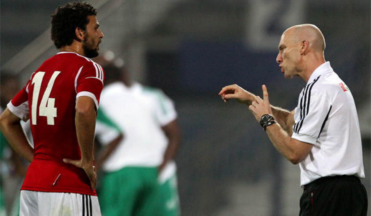 Egypt Coach Bob Bradley speaks to midfielder Hussam Ghali during a friendly match against Nigeria in April 2012.