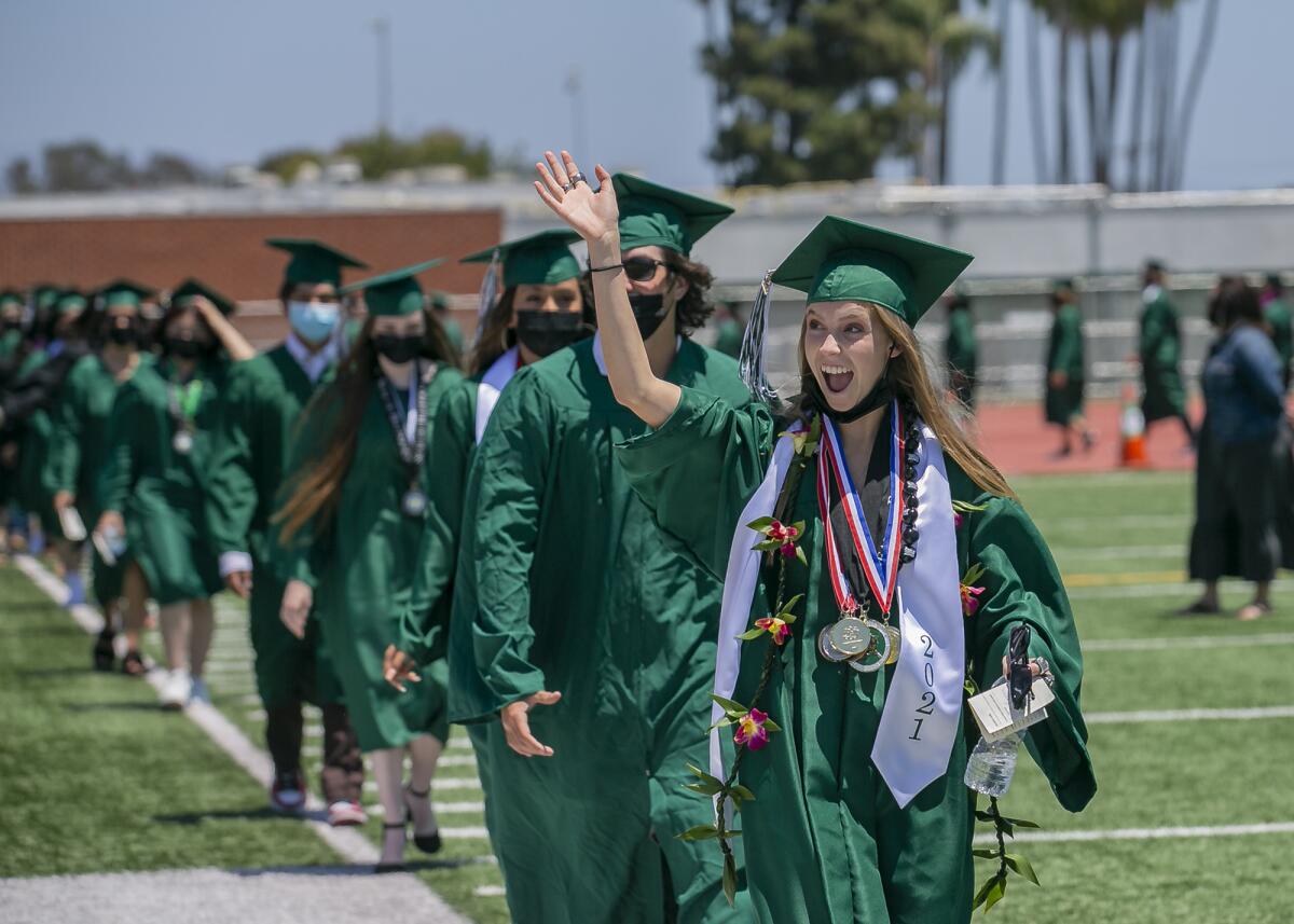 Kamea Binnquist waves to friends and family during Costa Mesa High School's graduation ceremony on Thursday, June 10, 2021.