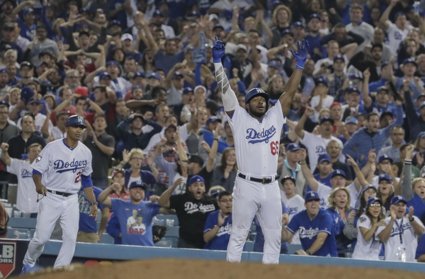 Dodgers Yasiel Puig reacts after reaching base on an error in the 13th inning, tying the score at 2.
