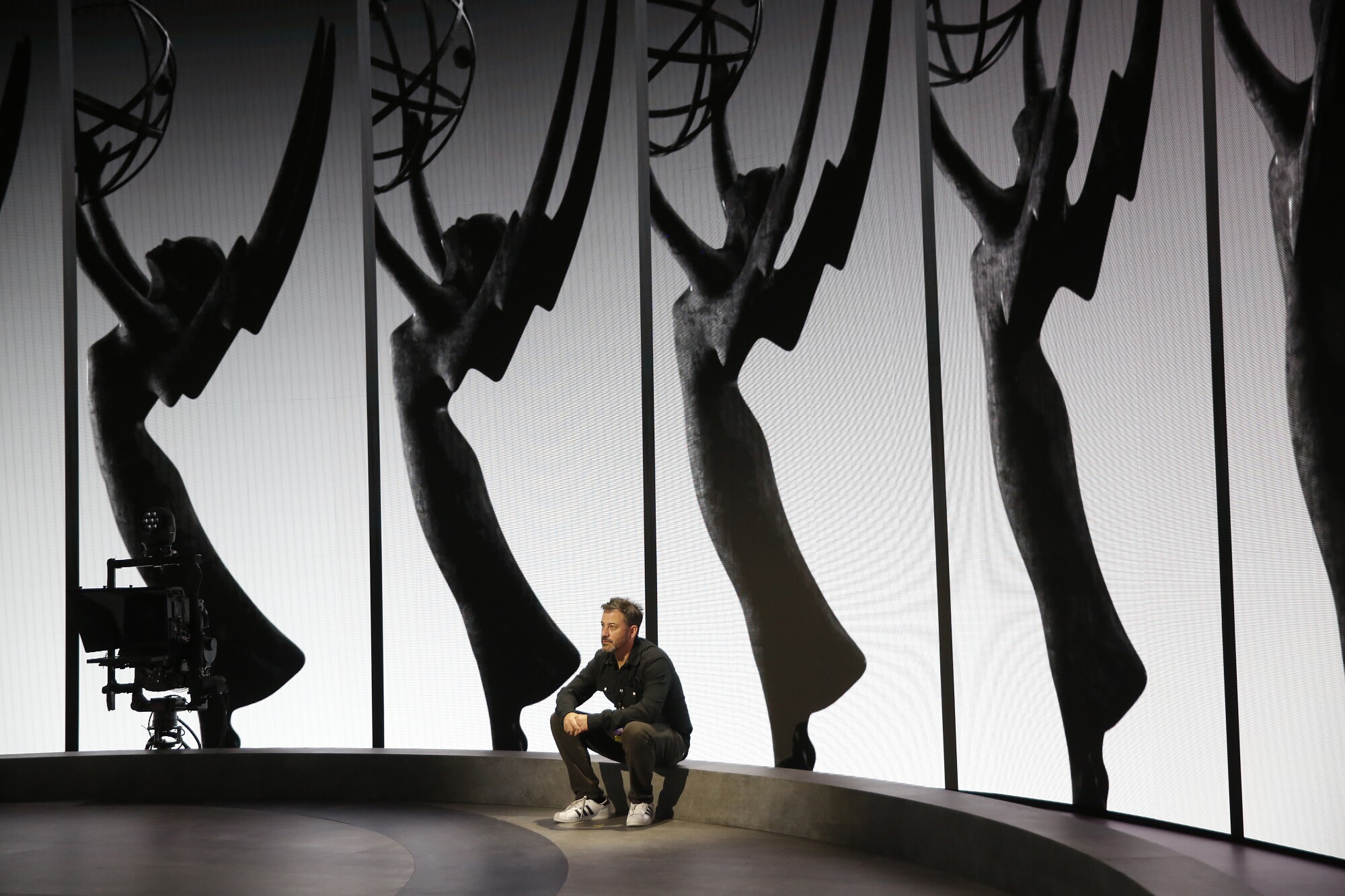 Emmy Host Jimmy Kimmel relaxes on the Emmy Awards stage.