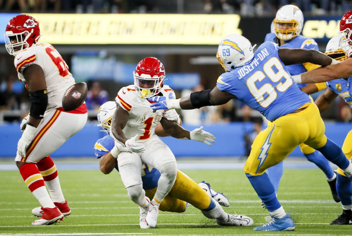 Chargers linebacker Troy Reeder forces the Chiefs' Jerick McKinnon (1) to fumble.  