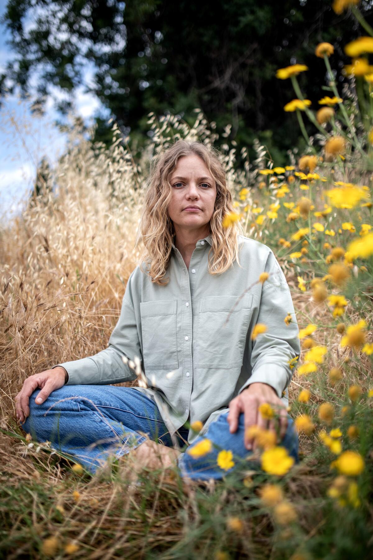 A woman sits in a flower farm