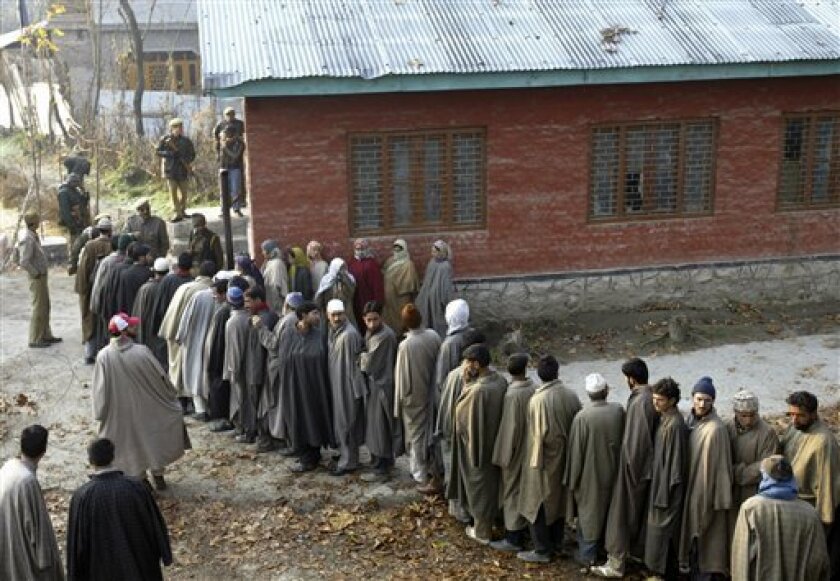 Kashmiris stand in a queue to cast vote at a polling station in Ganderbal, some 23 kilometers (14 miles) north of Srinagar, India, Sunday, Nov. 23, 2008. Government soldiers opened fire on hundreds of stone-throwing Muslims protesting against elections in Indian Kashmir on Saturday, killing two people and seriously wounding another, police said. (AP Photo/Dar Yasin)