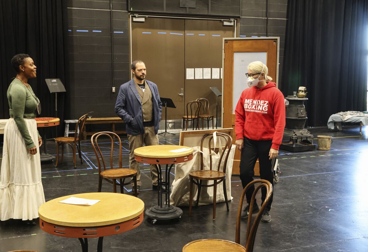 Playwright Kimber Lee (right) works with cast members Deidrie Henry and Paco Tolson.