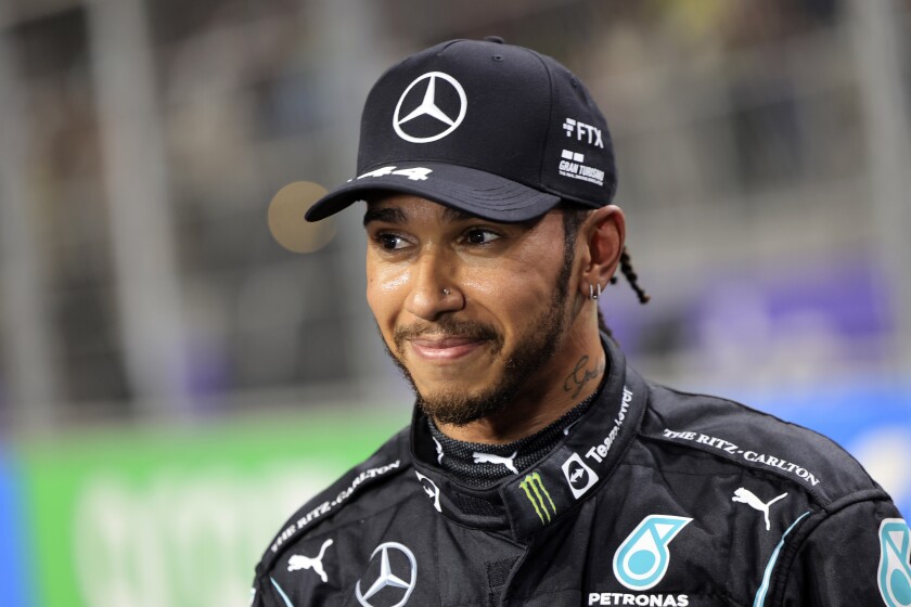 FILE- Mercedes driver Lewis Hamilton, of Britain smiles, after winning the pole position during qualifying for the Formula One Saudi Arabian Grand Prix auto race on Dec. 4, 2021, in Jiddah, Saudi Arabia. Hamilton returned to social media Saturday, Feb. 5, 2022, following a lengthy silence that dates to last season's controversial Formula 1 finale. (Giuseppe Cacace/Pool Photo via AP, File)