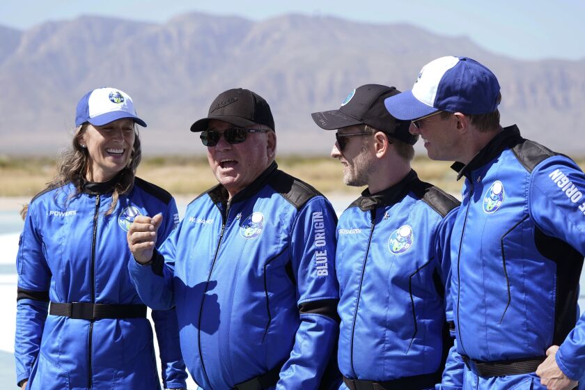 William Shatner, center right, speaks as Audrey Powers, left, Chris Boshuizen, center right, and Glen de Vries all look on during a media availability at the Blue Origin spaceport near Van Horn, Texas, Wednesday, Oct. 13, 2021. The “Star Trek” actor and the three fellow passengers hurtled to an altitude of 66.5 miles (107 kilometers) over the West Texas desert in the fully automated capsule, then safely parachuted back to Earth in a flight that lasted just over 10 minutes.(AP Photo/LM Otero)