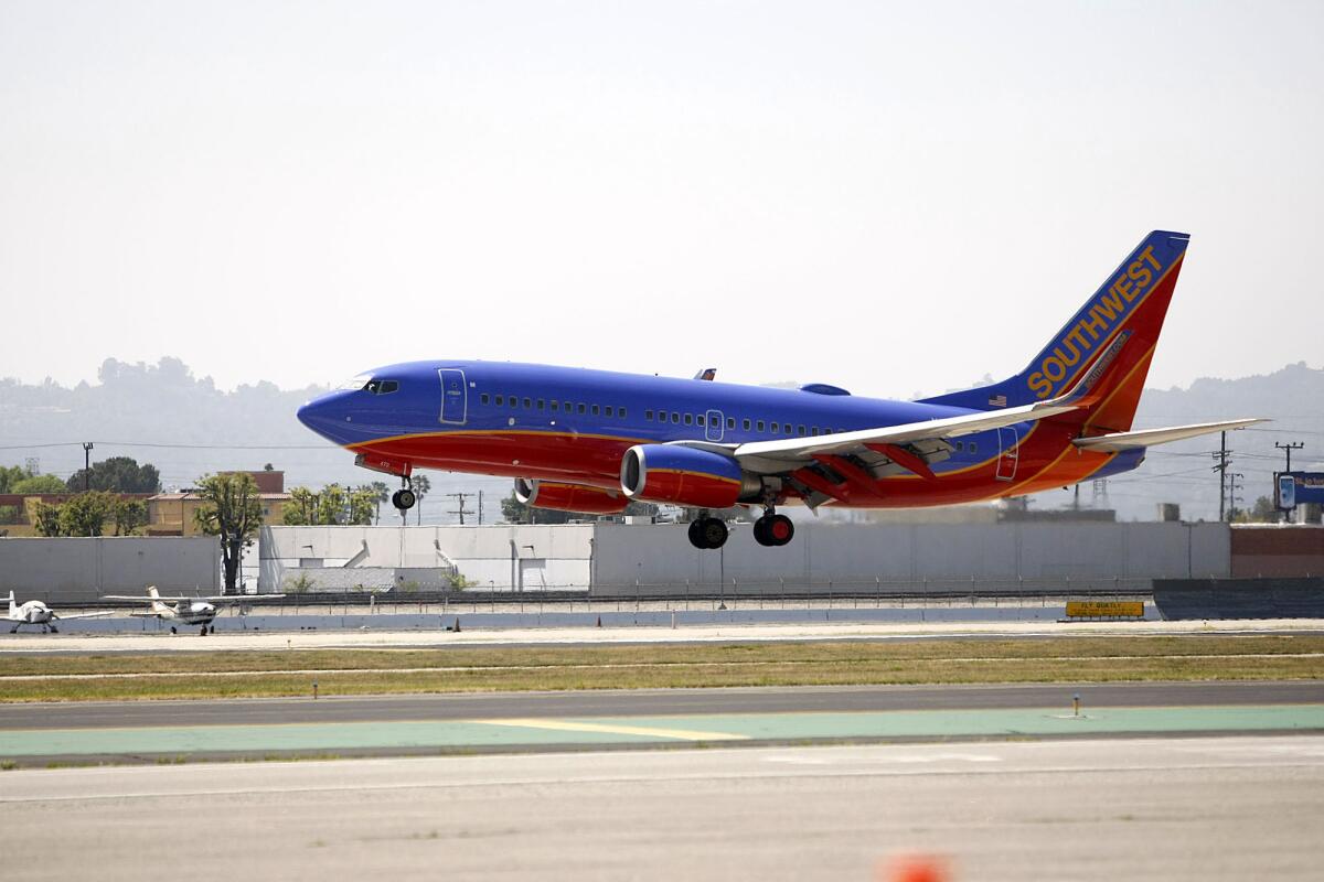A Southwest Airlines plane lands at the Burbank Airport on Saturday, March 23, 2013.