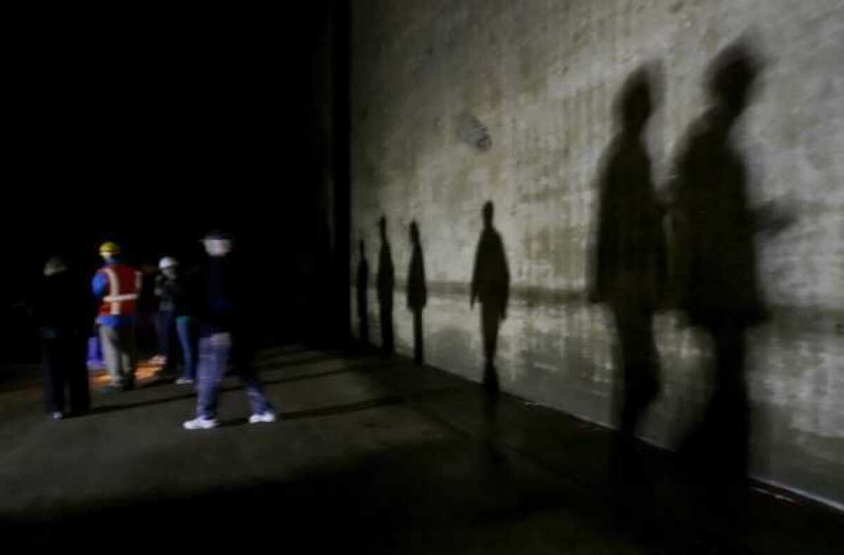 Local residents' shadows can be seen on the concrete wall of the Diederich Reservoir during a rare tour of the underground reservoir earlier this year. Glendale recently finished upgrading the reservoir.