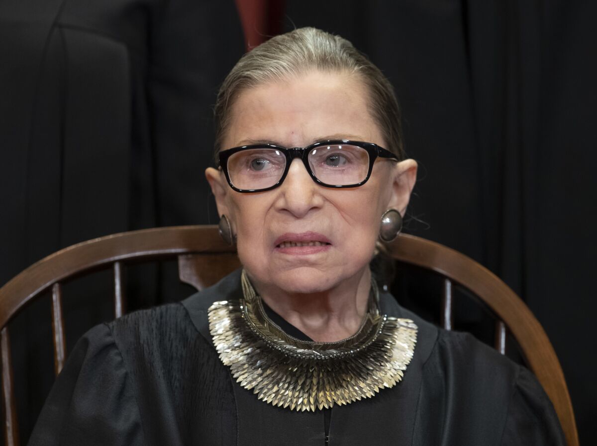 Supreme Court Associate Justice Ruth Bader Ginsburg is pictured in black robes and glasses in 2018