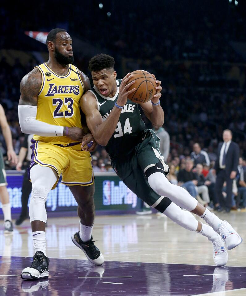 LeBron James defends Bucks forward Giannis Antetokounmpo during the first half of a game March 6 at Staples Center.