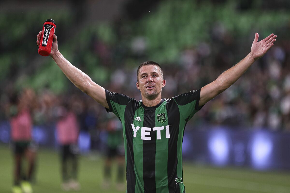 FILE - Austin FC defender Matt Besler waves to the crowd after the team's win over the Houston Dynamo in an MLS soccer match in Austin, Texas, Wednesday, Aug. 4, 2021. Former U.S. men's national team defender Matt Besler, who spent 13 seasons in Major League Soccer and was a five-time All-Star, announced his retirement Wednesday, Nov. 10, 2021. (Aaron E. Martinez/Austin American-Statesman via AP, File)