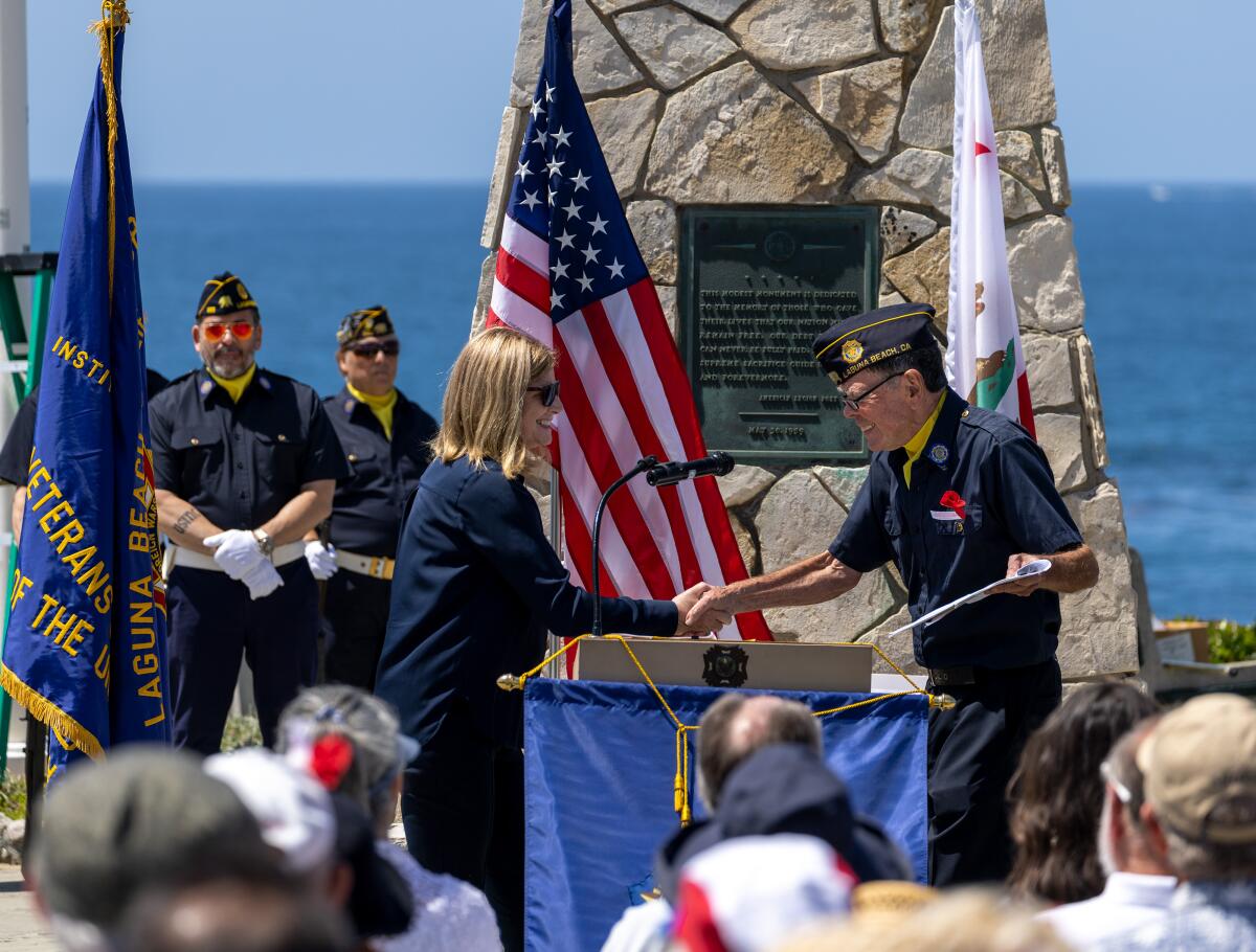 American Legion Post Commander Richard Moore, right, welcomes Laguna Beach Mayor Sue Kempf.