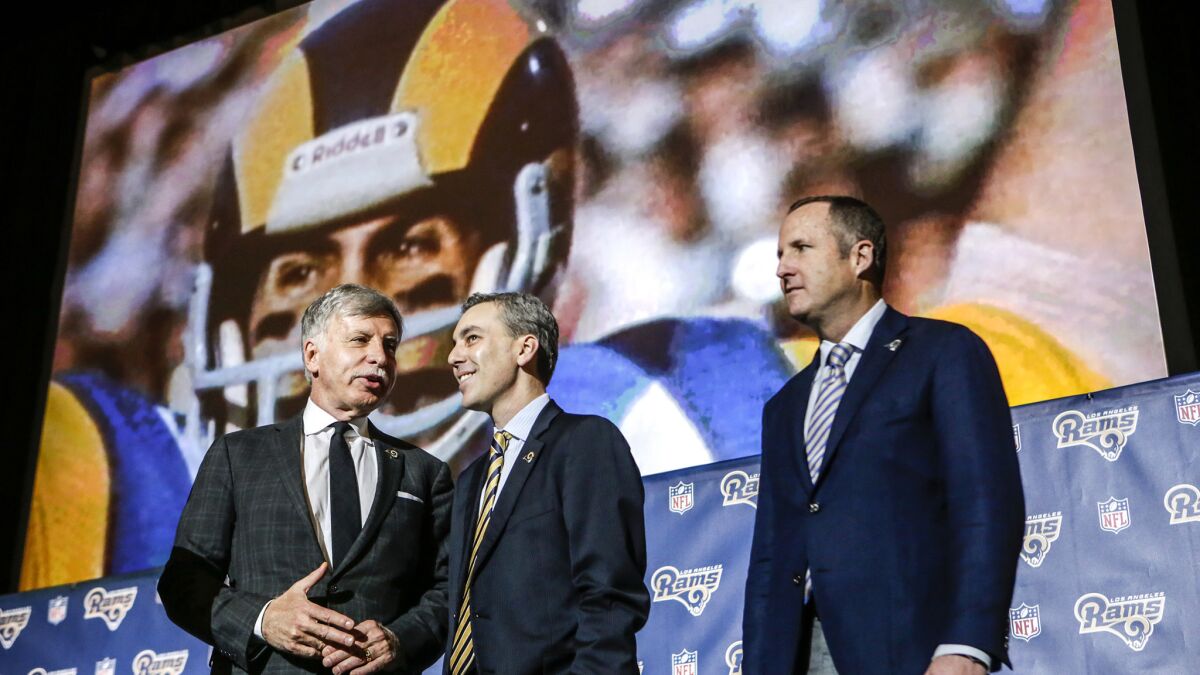 Rams owner Stan Kroenke, left, is joined by chief executive Kevin Demoff, center, and Chris Meany of Hollywood Park Land Co. after the news conference to formally announce the team's return to L.A.