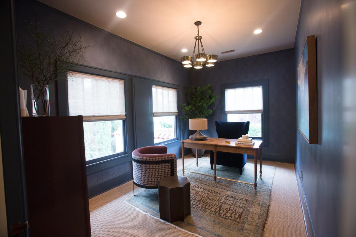 In what's called a writer's retreat, Savannah Bleue and Ally Marks create a masculine office with deep blue and burgundy tones, velvet and lacquered furniture, Pierre Frey wallpaper and a classic oak desk. "We wanted it to feel moody so it would evoke creativity," added Bleue.