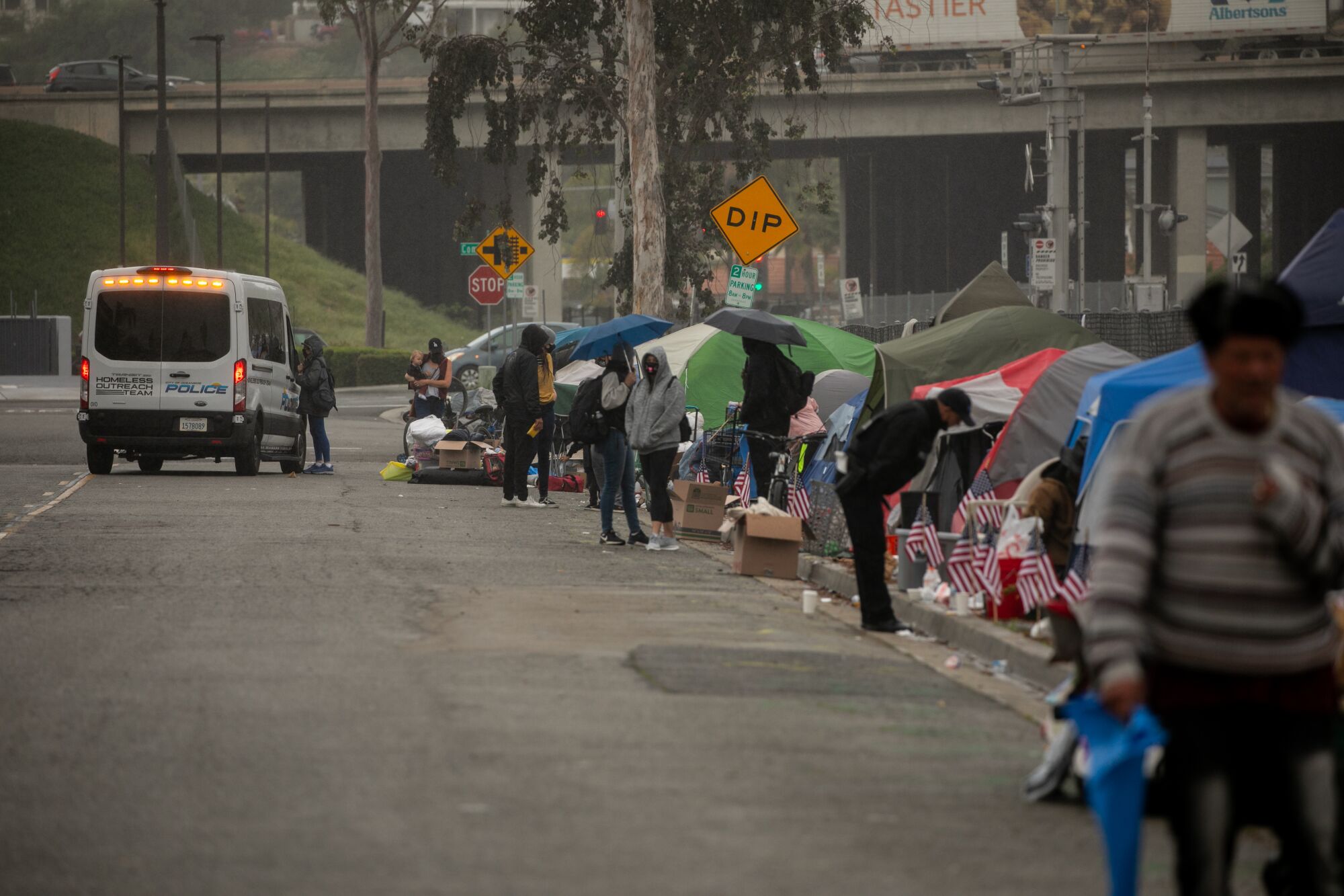 Oceanside Police being clearing a homeless encampment near Oceanside Boulevard on Tuesday.