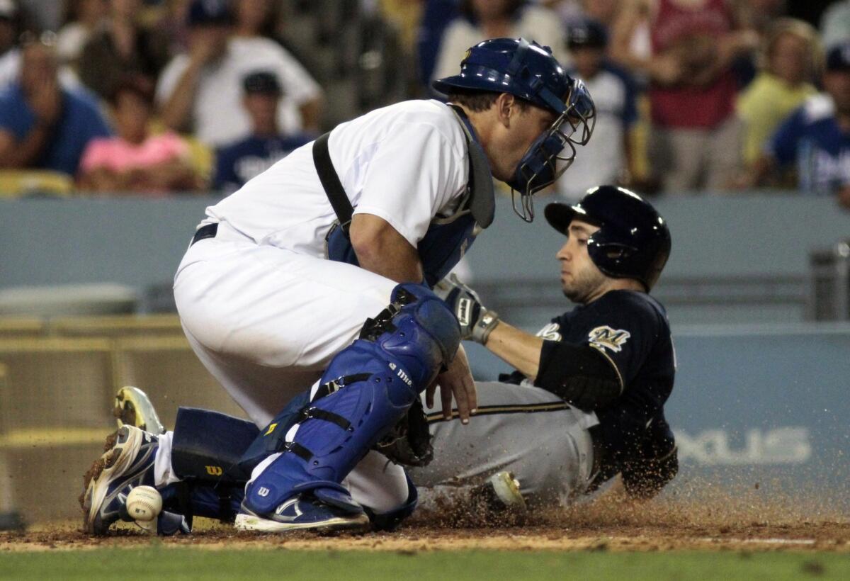 Milwaukee right-fielder Ryan Braun scores in the 8th inning as the ball slips past Dodgers catcher A.J. Ellis.