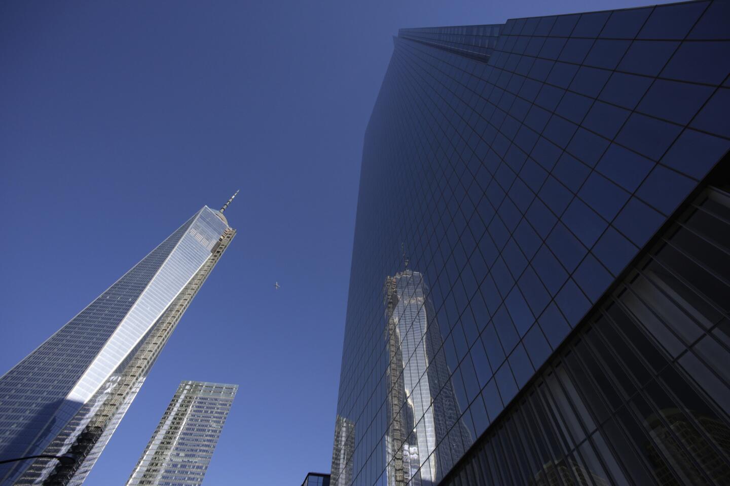 One World Trade Center, left, is reflected in the glass facade of its neighbor, 4 World Trade Center.