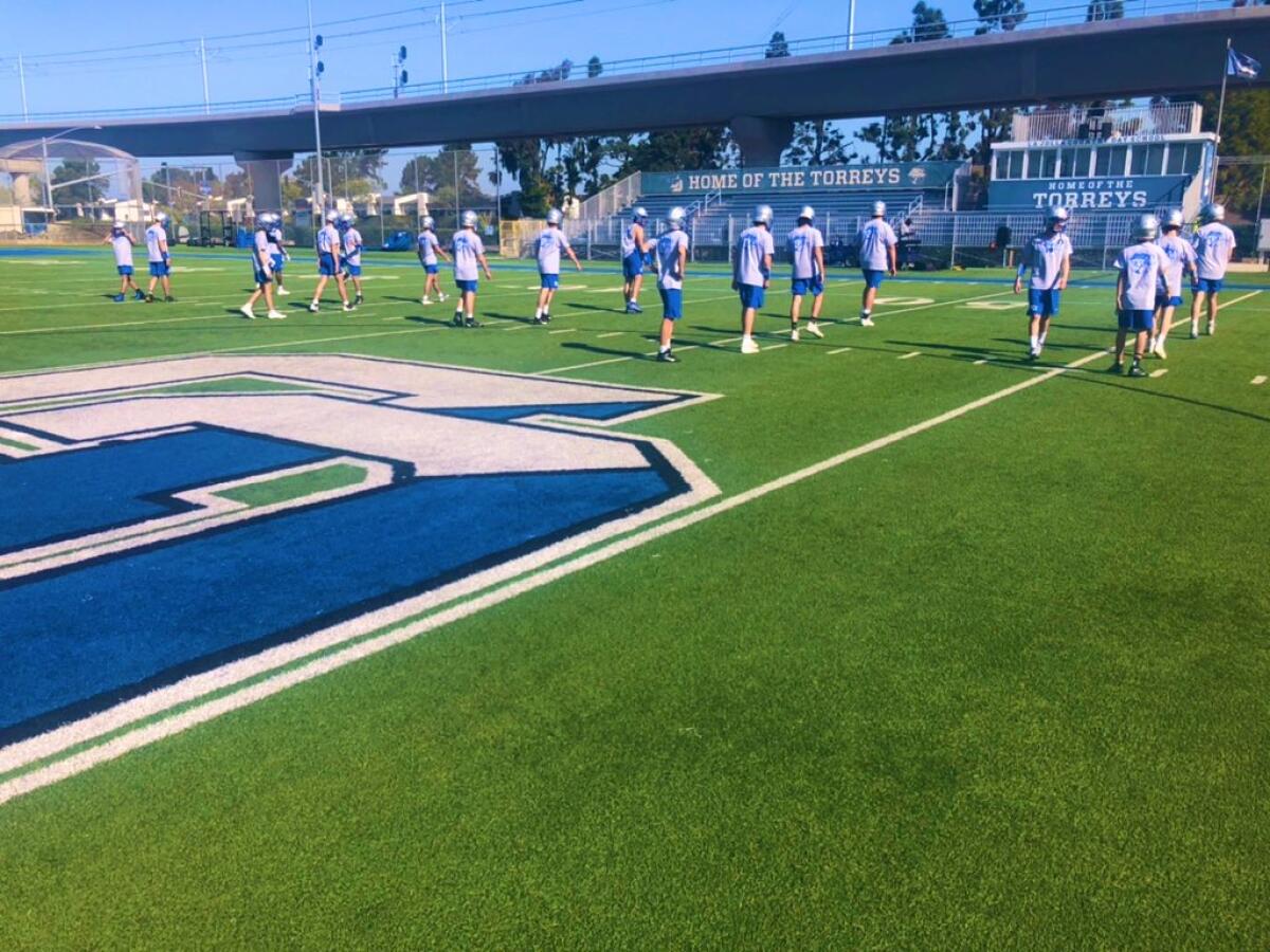 La Jolla Country Day School football players prepare for the new season with a coronavirus-cautious practice.