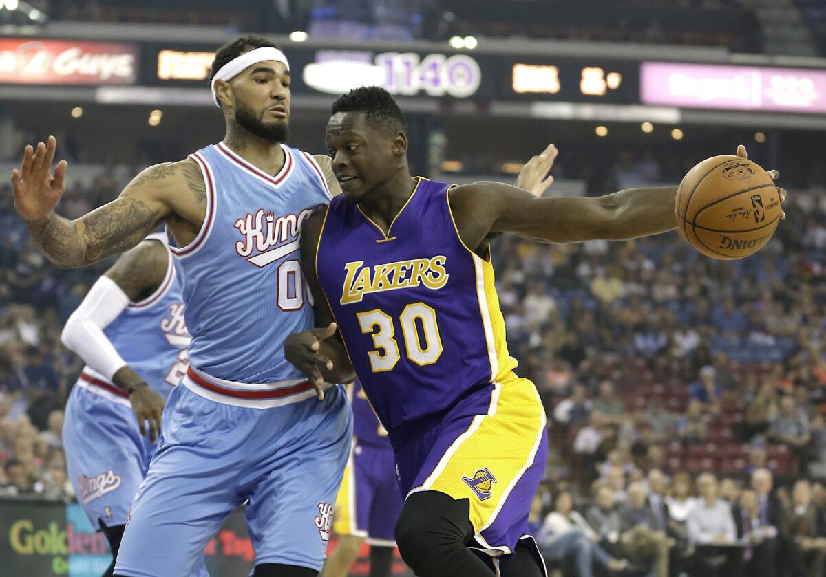 Sacramento Kings center Willie Cauley-Stein, left, stops the drive of Los Angeles Lakers forward Julius Randle during the first quarter on Friday.