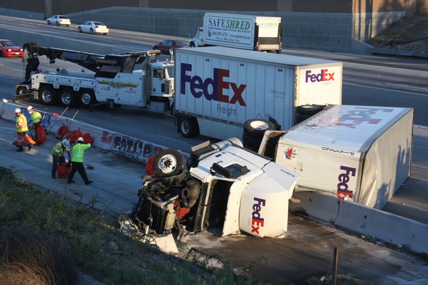 FedEx truck swerves to avoid two crashes, topples on 5 Freeway Los
