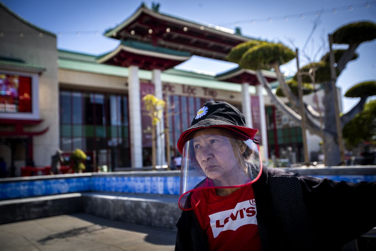 Xuan Nguyen wears a face shield at the Asian Garden Mall.