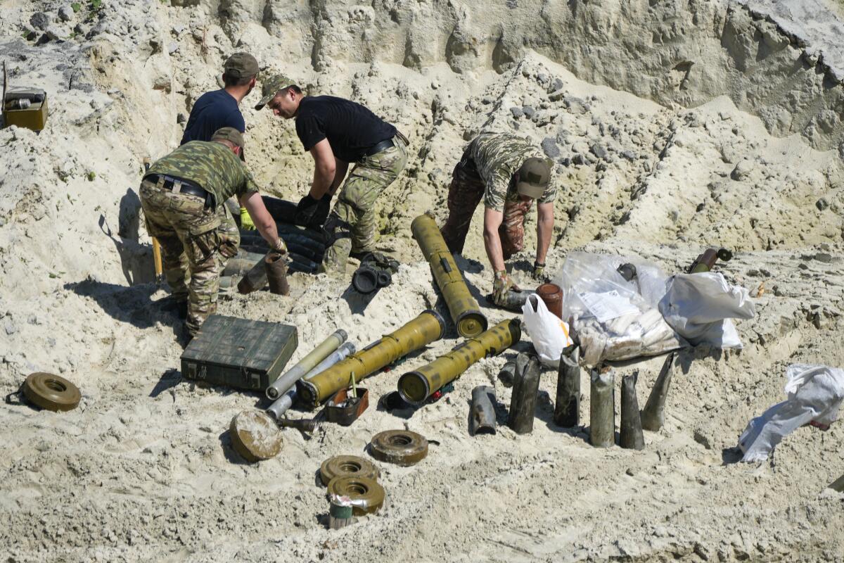 Ukrainian servicemen with unexploded Russian ordnance