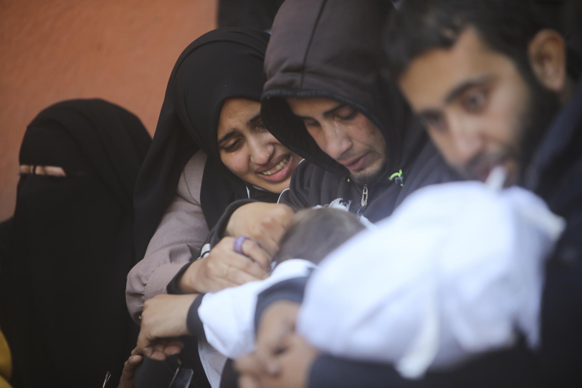 People mourning a relative killed in the Israeli bombardment of Gaza
