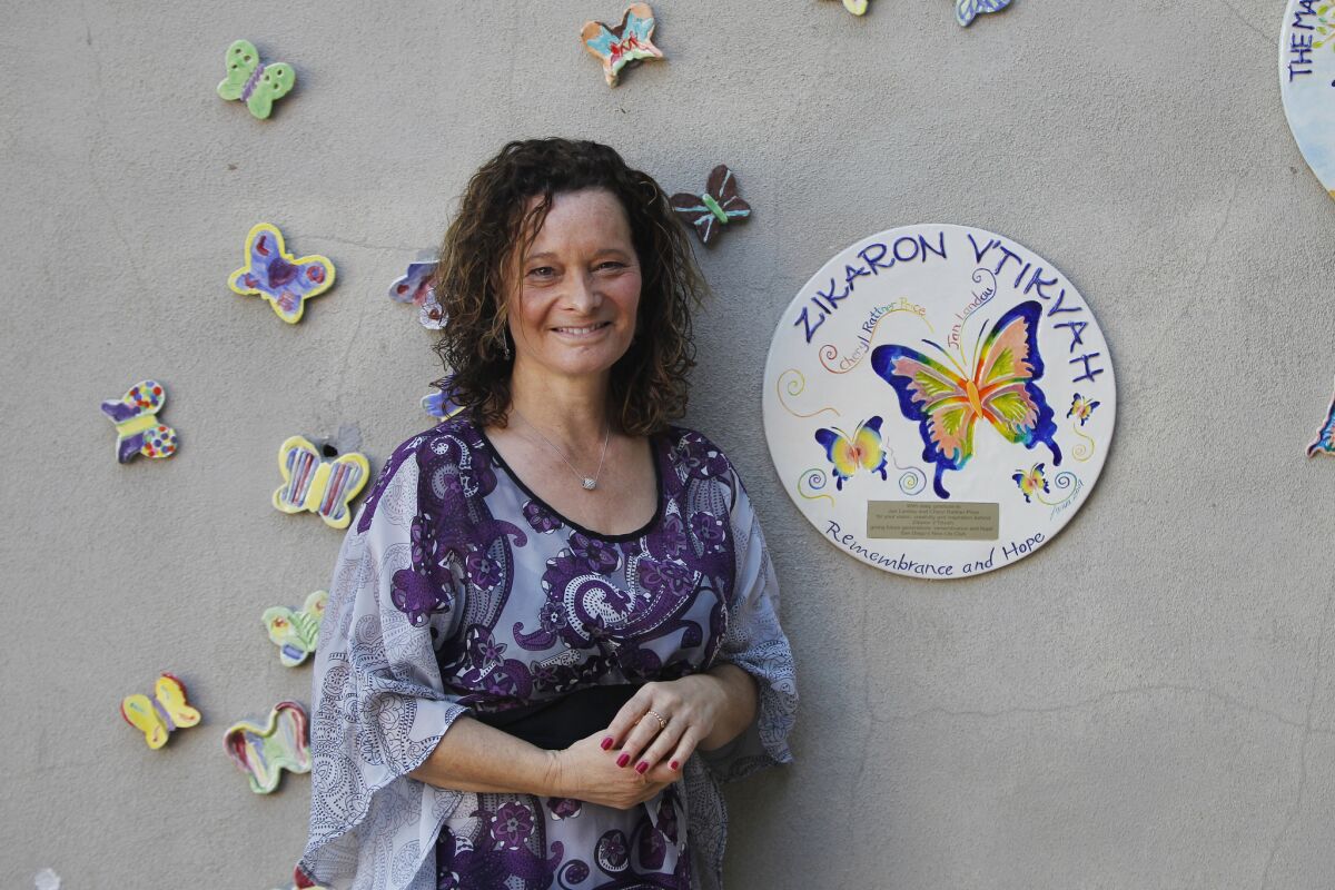 Butterfly Project director Cheryl Rattner Price with a display of hand-painted butterflies at San Diego Jewish Academy. She has just finished a film on the project, which seeks to create butterflies for each of the 1.5 million Jewish children who died in the Holocaust.