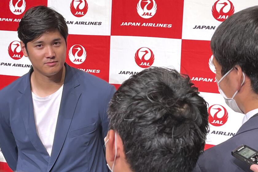 Los Angeles Angels' Shohei Ohtani speaks to reporters after he returned home, at the Haneda international airport in Tokyo