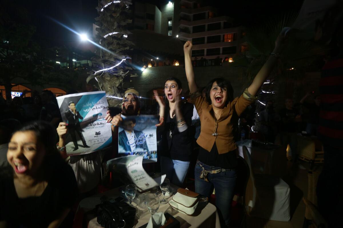Viewers react with joy as television shows Palestinian singer Muhammed Assaf winning the "Arab Idol" talent contest June 22.