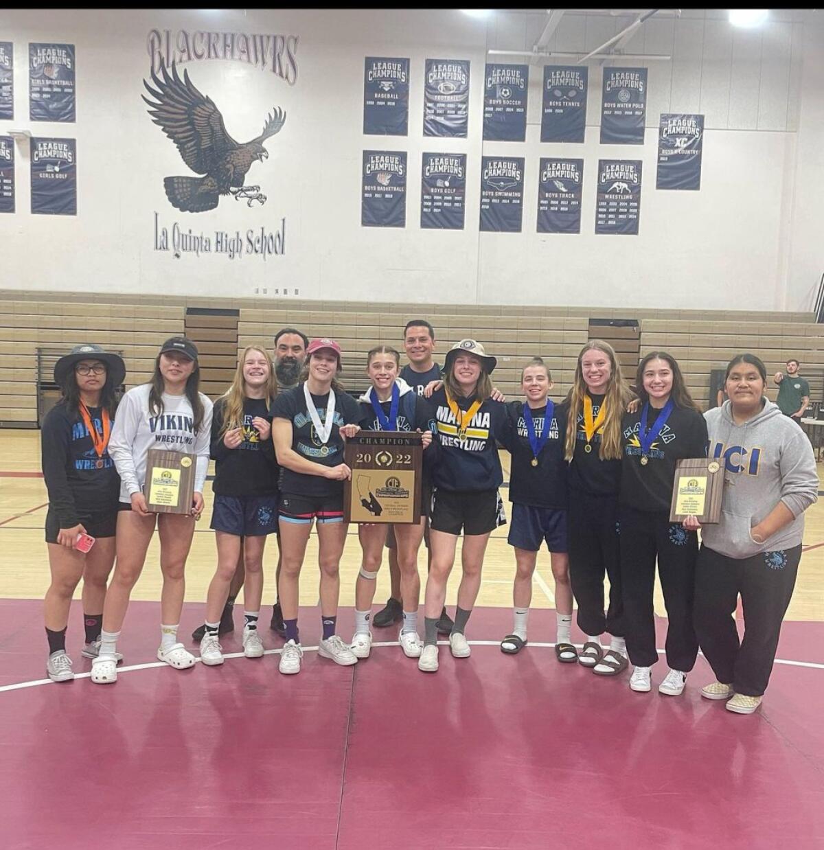 The Marina High School girls' wrestling team celebrates its victory in the CIF Southern Section Central Division.  