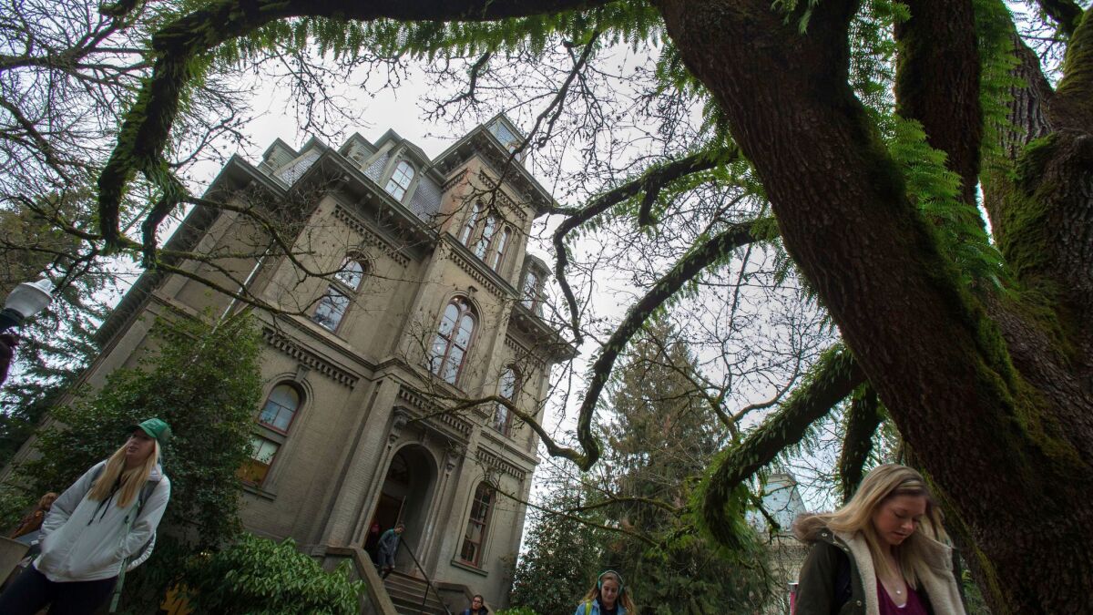 Students exit Deady Hall on the campus of the University of Oregon Wednesday on Jan. 25.