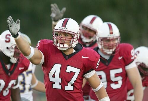 Kevin Schimmelmann of the Stanford Cardinal signals a turnover after the Cardinal recovers a Bruins' fumble.