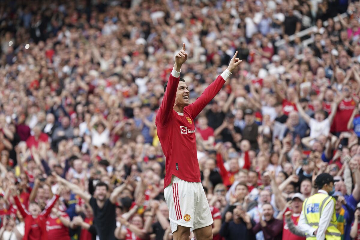Manchester United's Cristiano Ronaldo celebrates after scoring his third goal during the English Premier League soccer match between Manchester United and Norwich City at Old Trafford stadium in Manchester, England, Saturday, April 16, 2022. (AP Photo/Jon Super)
