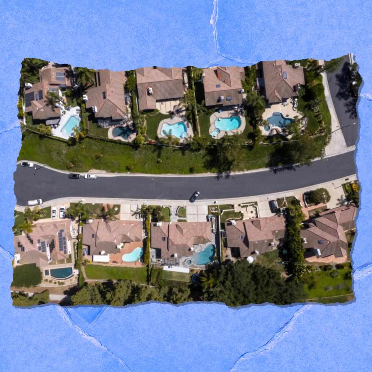An aerial view of houses — many with swimming pools.