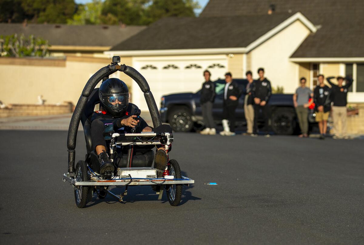 Kirin Kunkle, 17, with the Huntington Beach High School Oilers electric race car team, takes a test drive.