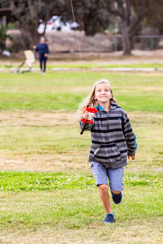 Ryder Nelson turns kite aviator at Robb Field.